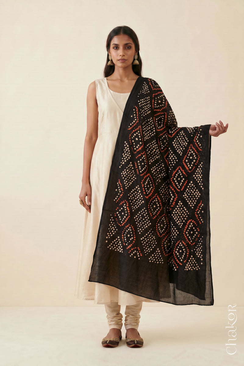 Black Bandhej dupatta in pure mulmul cotton worn with a neutral outfit.
