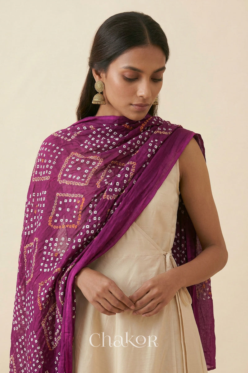 Magenta Kutch Bandhani dupatta styled around the neck in soft mercerised mulmul cotton.
