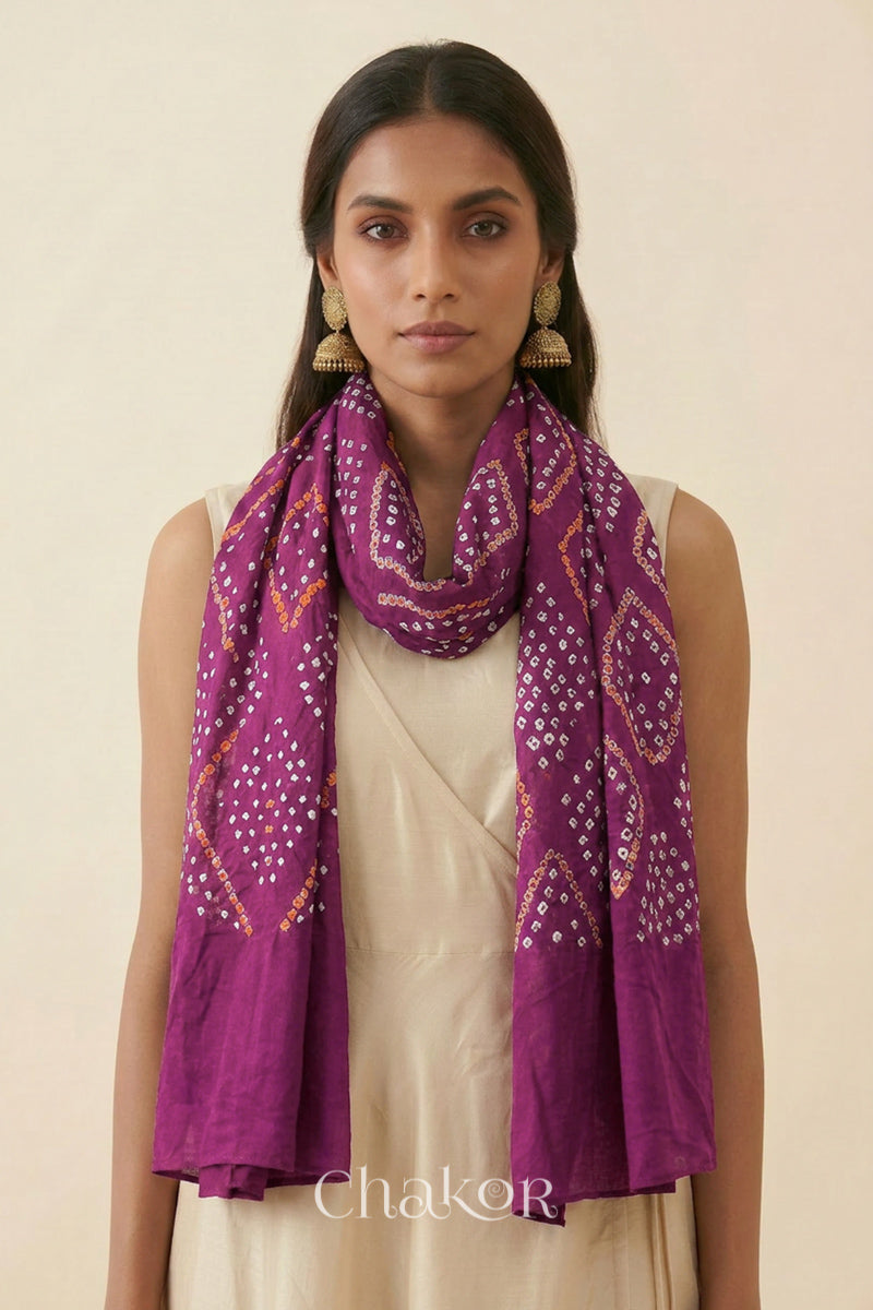 Magenta Kutch Bandhani dupatta styled around the neck in soft mercerised mulmul cotton.
