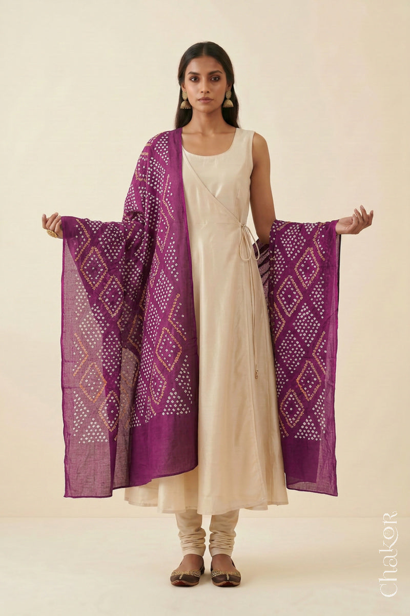 Magenta Bandhej dupatta in pure mulmul cotton worn with a neutral outfit.
