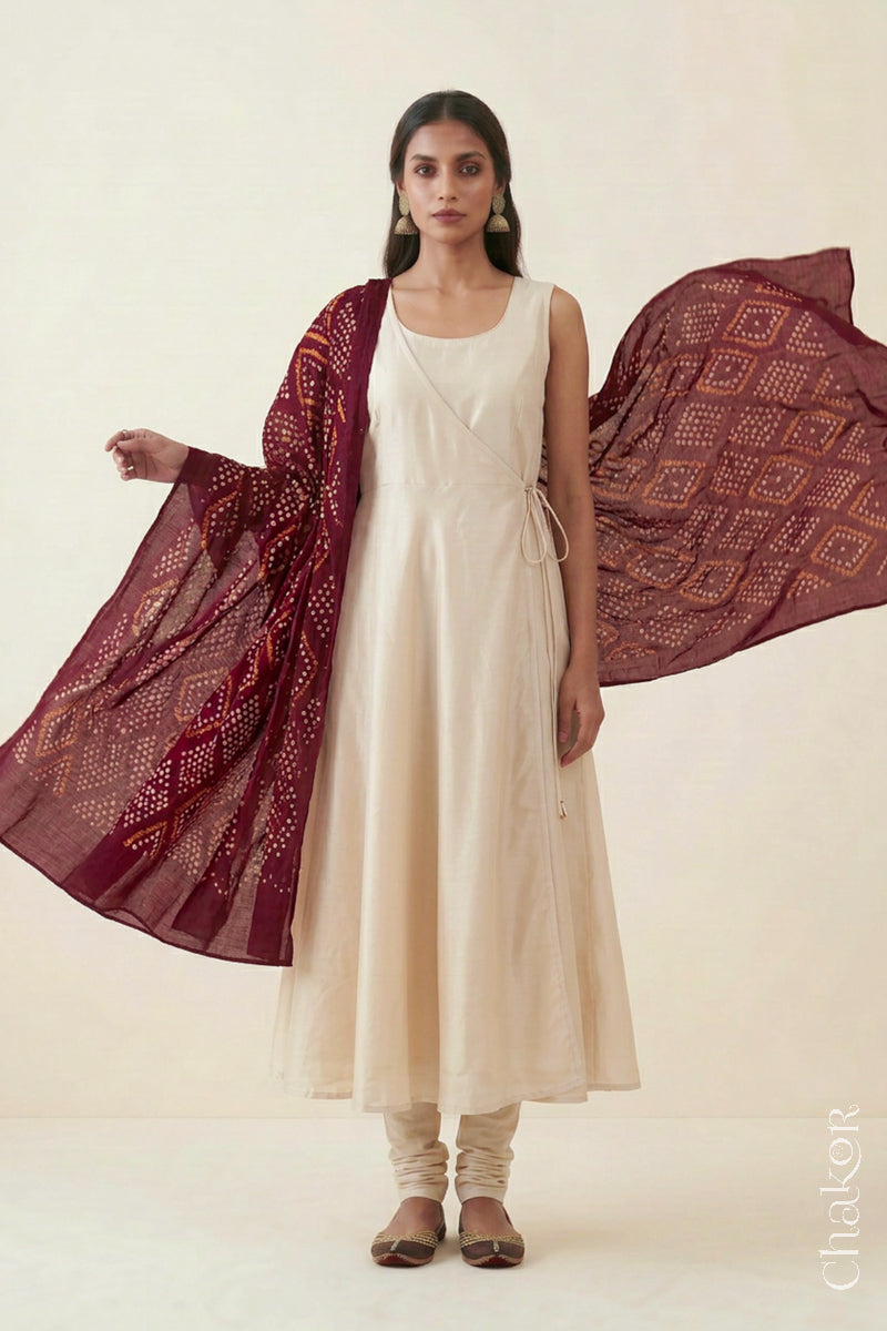 Maroon handmade Bandhani mulmul cotton dupatta shown in flowing drape.
