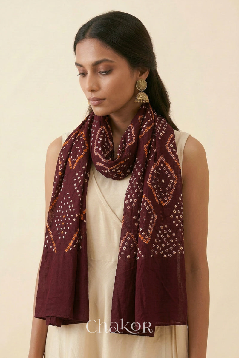 Maroon Kutch Bandhani dupatta styled around the neck in soft mercerised mulmul cotton.
