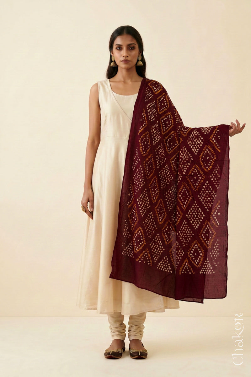 Maroon Bandhej dupatta in pure mulmul cotton worn with a neutral outfit.
