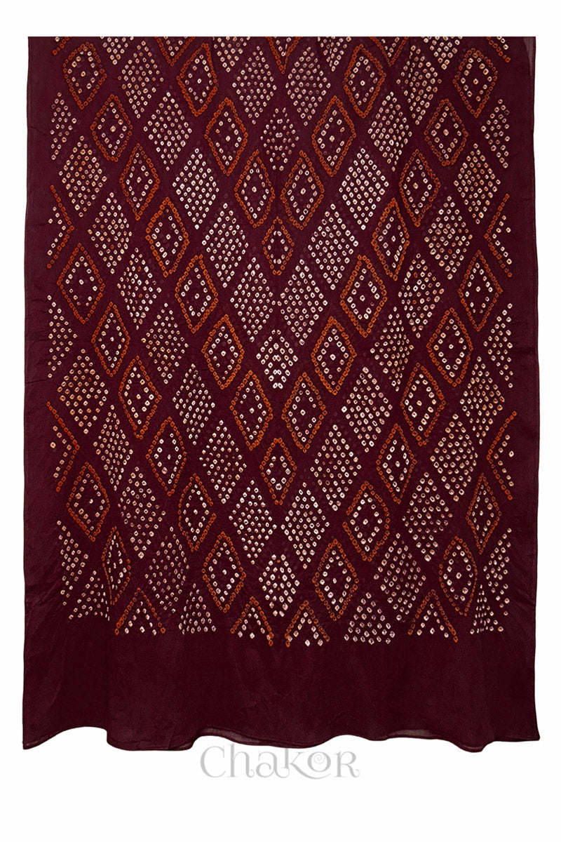 Full view of maroon handmade Bandhani dupatta in mercerised mulmul cotton.
