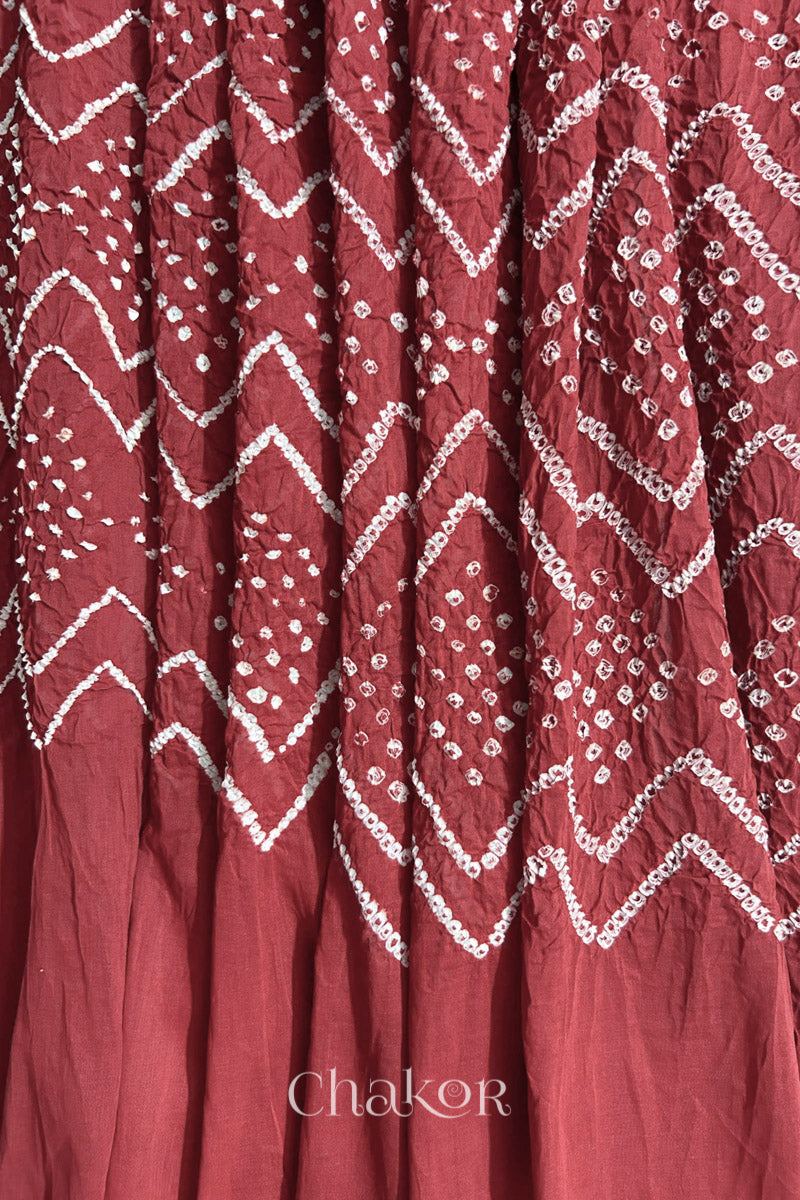 Detailed view of Bandhani tie-dye pattern and fabric fall on Dusty red cotton dupatta.
