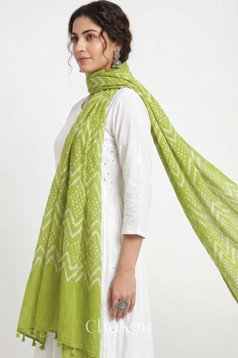 Hand tied Lime Green Kutch Bandhani dupatta in pure mercerised mulmul cotton worn by model.
