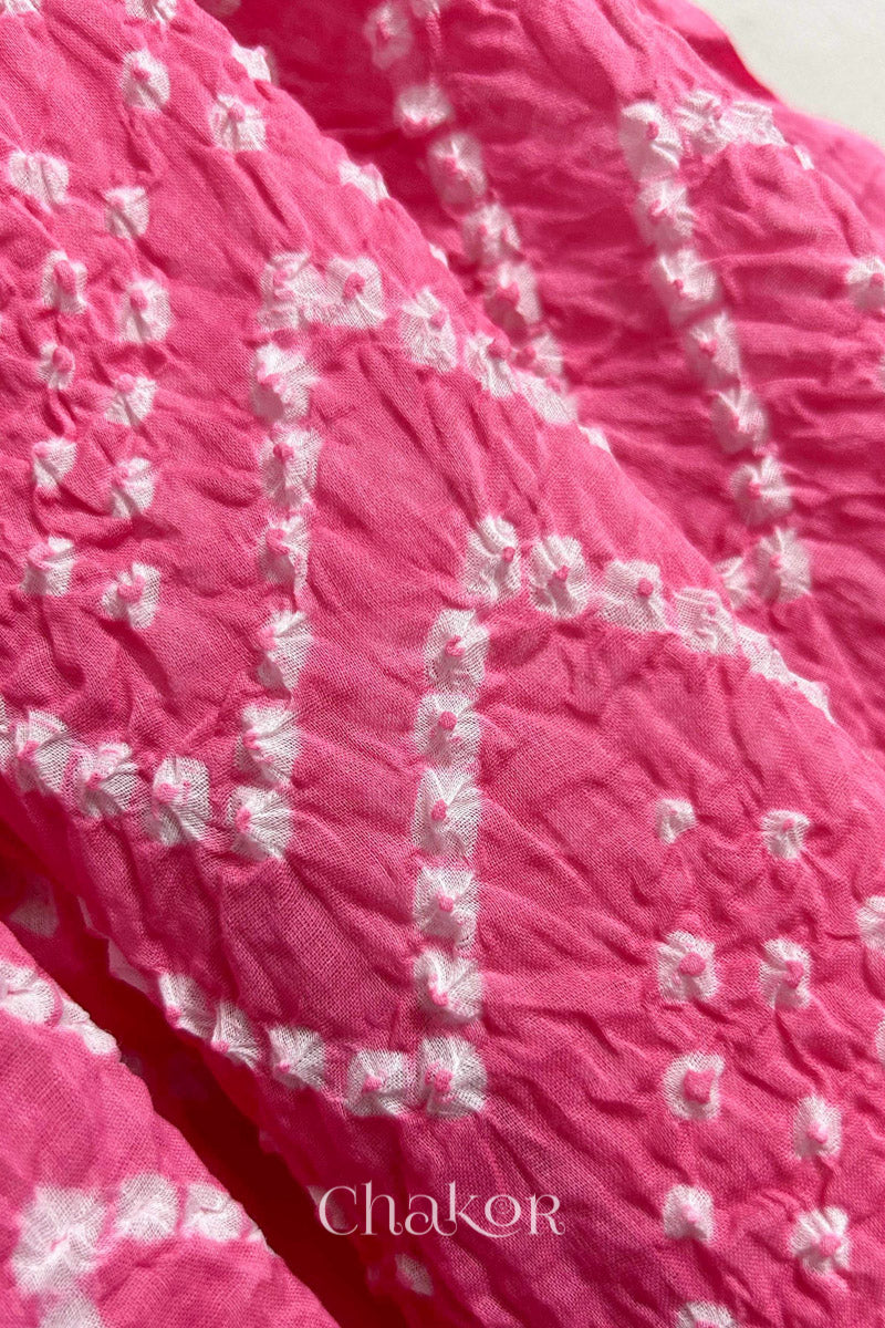 Close up of Traditional hand tied Bandhani pattern on Pink mulmul cotton dupatta.
