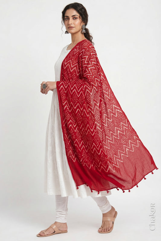 Red Kutch Bandhani dupatta in mercerised mulmul cotton shown in side drape styling.
