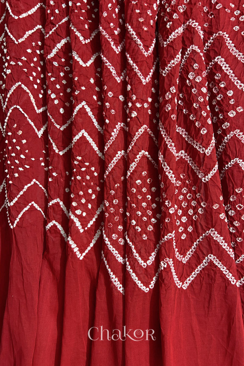 Detailed view of Bandhani tie-dye pattern and fabric fall on Red cotton dupatta.
