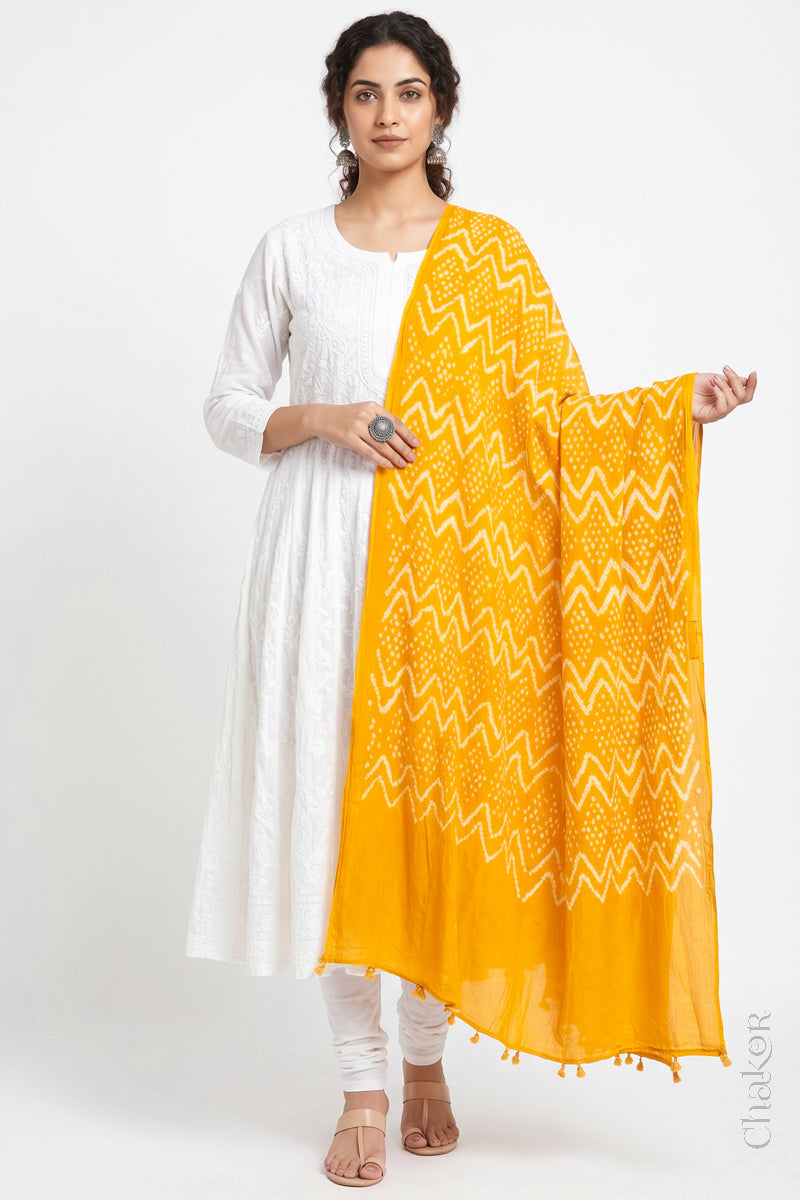 Yellow Kutch Bandhani dupatta in lightweight mercerised mulmul cotton with flowing drape.
