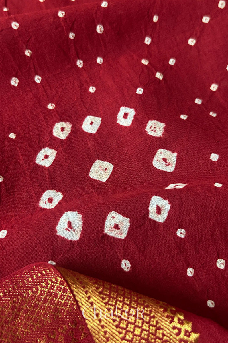 Close-up of white pearl-like dots in the Red Kutch Bandhani tie-dye pattern.
