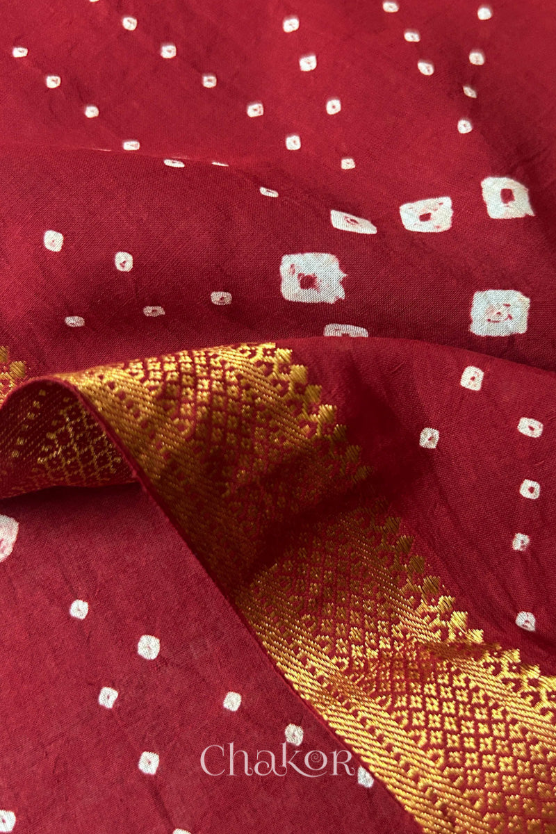 Close-up of the golden zari border on Red handloom Mangalgiri cotton Bandhani dupatta.
