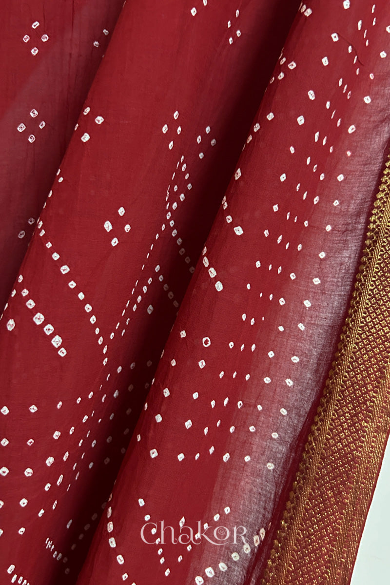 Close-up of Red Mangalgiri cotton fabric showing its handloom weave and opacity.
