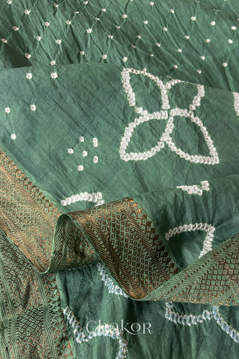 Close-up of white pearl-like dots in the Moss Green Kutch Bandhani tie-dye pattern.
