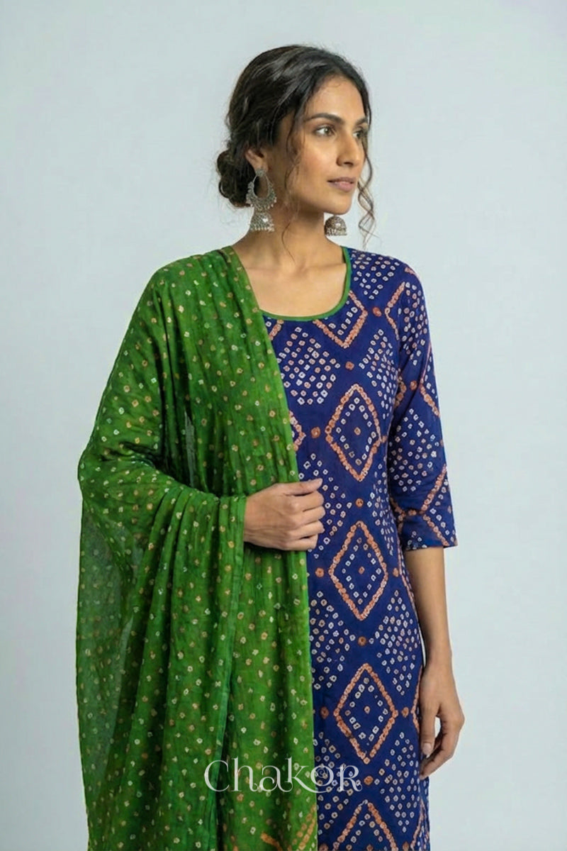 Model wearing Handcrafted Blue Bandhani Cotton Kurta and Mehendi green Pant Set with Dupatta with traditional design and hand embroidery.