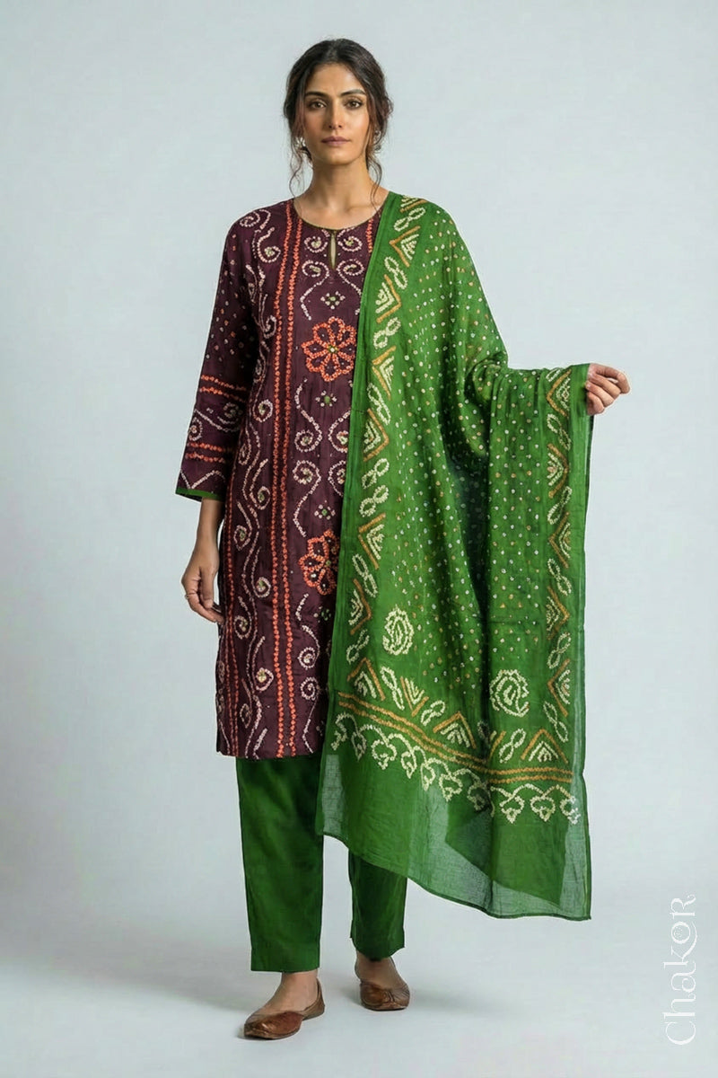 Model wearing Handcrafted Brown Bandhani Cotton Kurta and green Pant Set with Dupatta with traditional floral design and mirror and mukaish hand embroidery.
