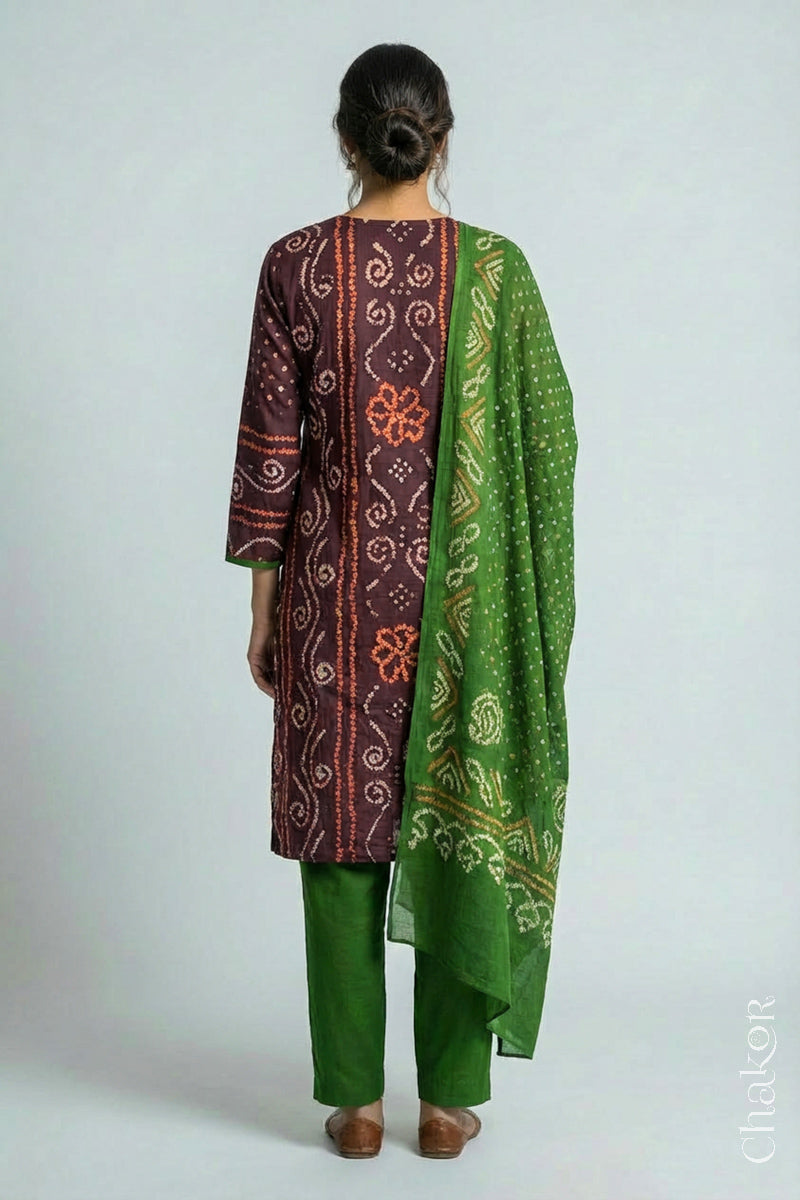 Model wearing Handcrafted Brown Bandhani Cotton Kurta and green Pant Set with Dupatta with traditional floral design and mirror and mukaish hand embroidery.