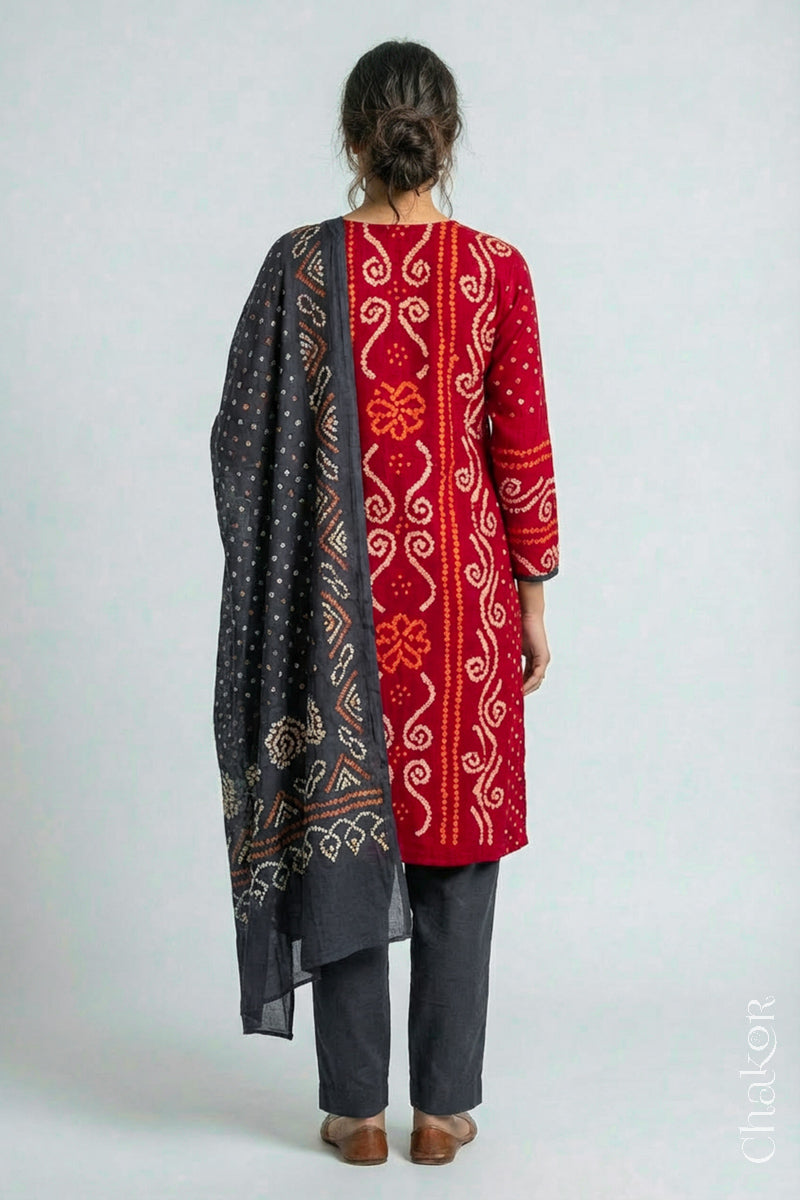 Model wearing Red Bandhani Cotton Tunic with Charcoal gray Pant with Dupatta, Handcrafted in Kutch with traditional design and hand embroidery.