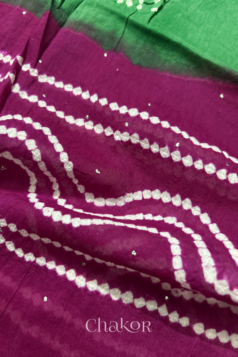 Mulmul cotton bandhani fabric with mukaish embroidery detail in green and magenta.
