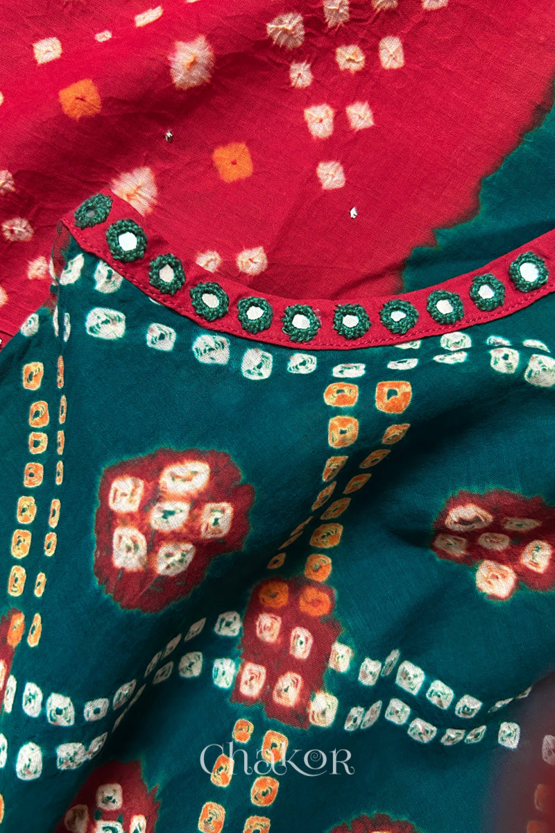 Mirror work neckline detail on mulmul cotton bandhani kaftan in green and red, handcrafted in Kutch.
