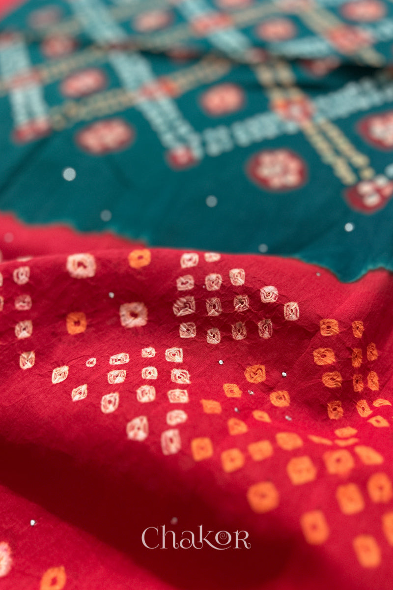 Mulmul cotton bandhani fabric with mukaish embroidery detail in green and red.
