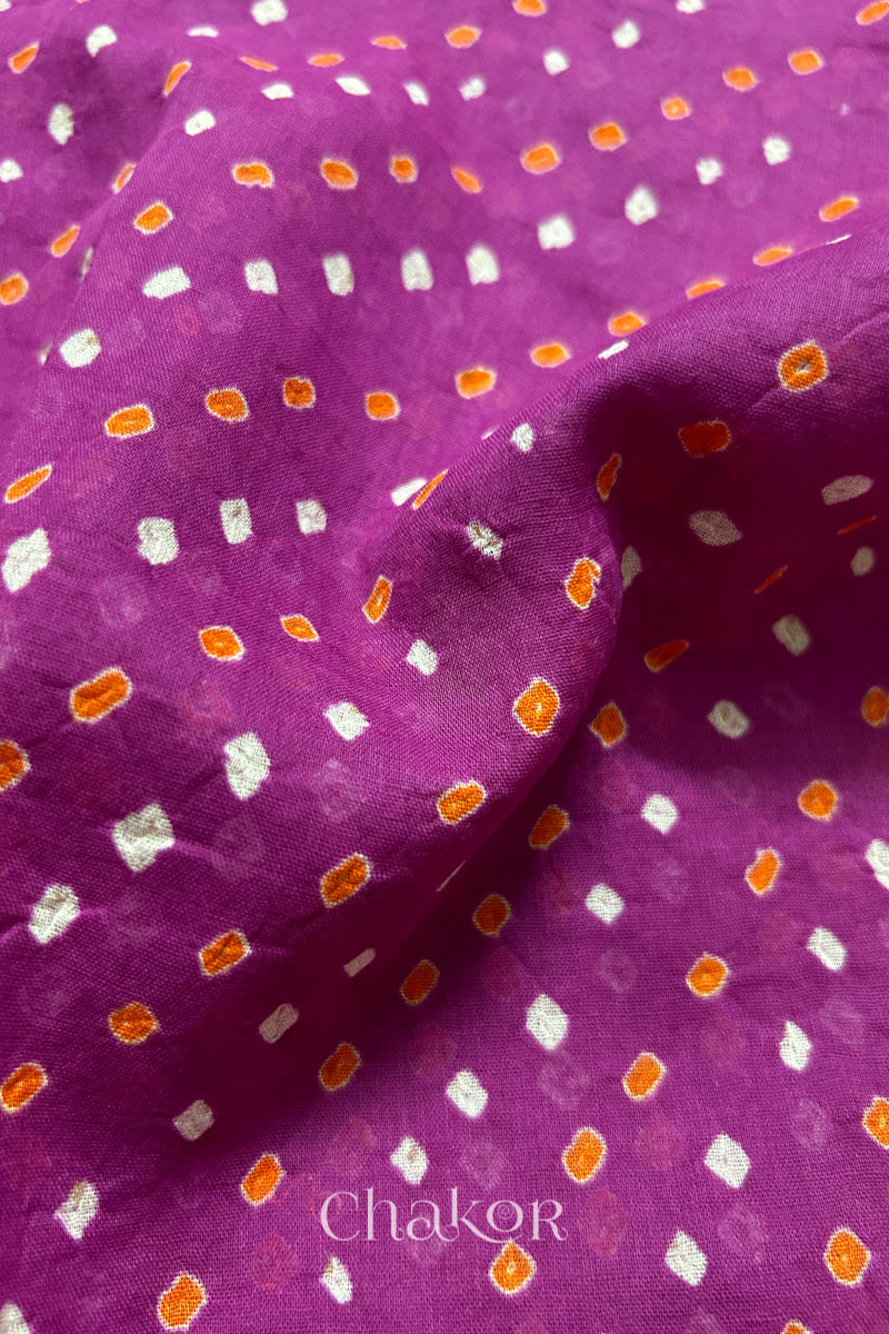 Mulmul cotton bandhani fabric with mukaish embroidery detail in magenta.
