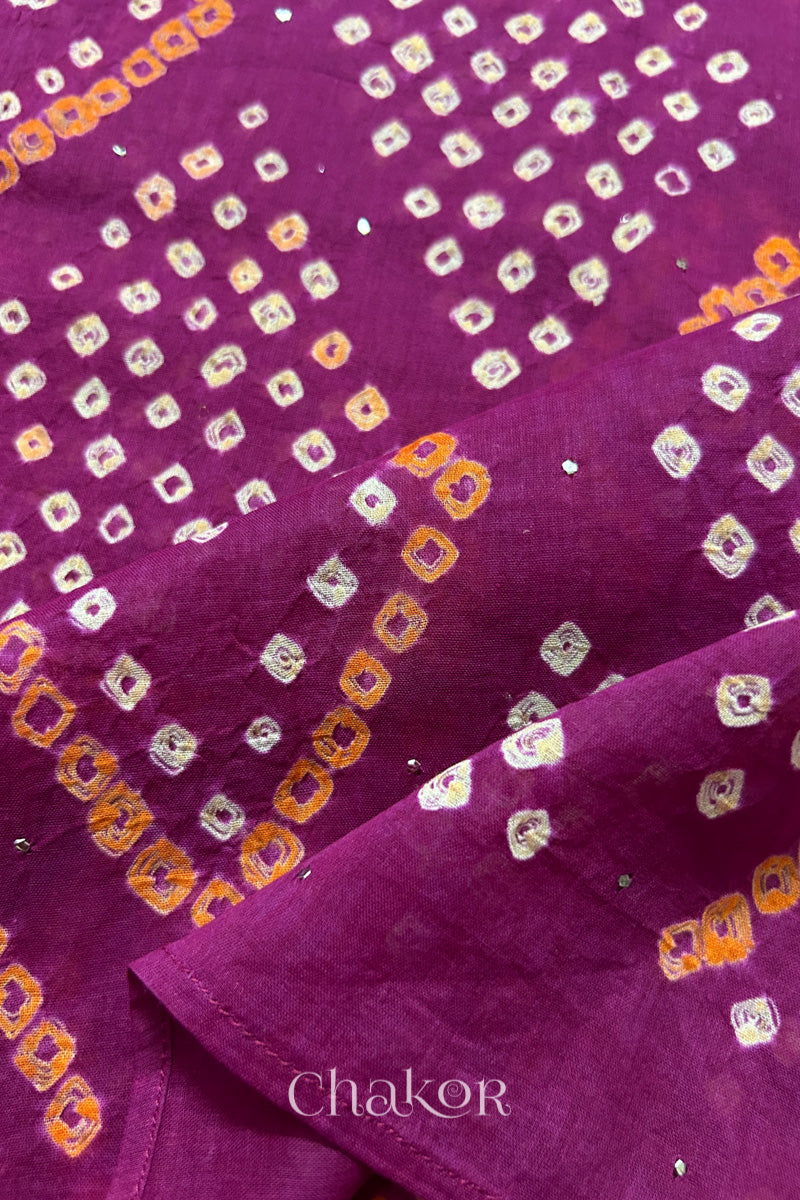 Mulmul cotton bandhani fabric with mukaish embroidery detail in magenta.
