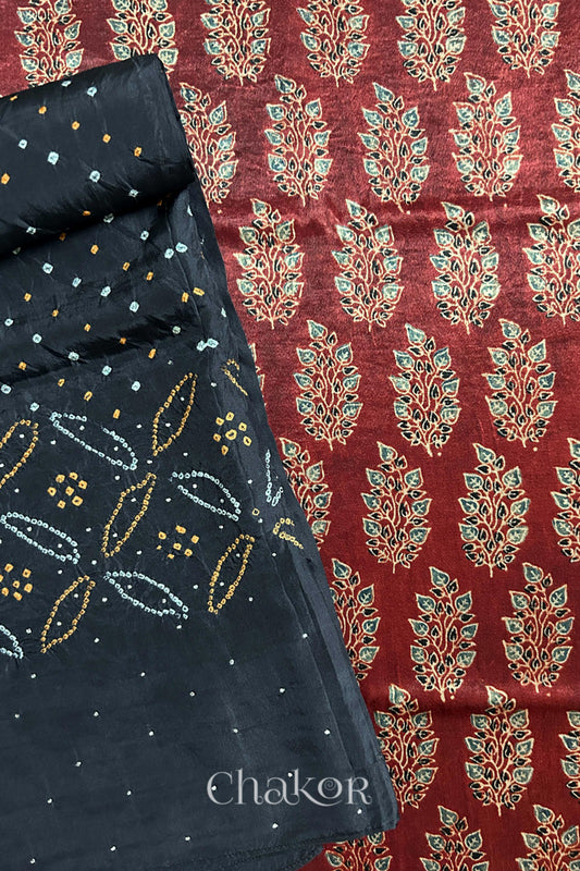 Madder red ajrakh block printed mashru silk kurta fabric paired with black bandhani mulberry silk dupatta featuring mukaish work on pallu.