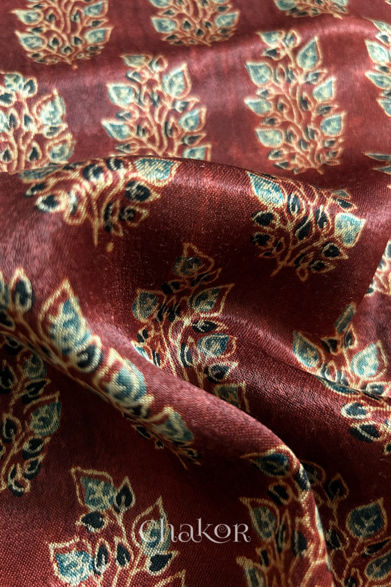 Close up of madder red ajrakh block printed mashru silk kurta fabric.