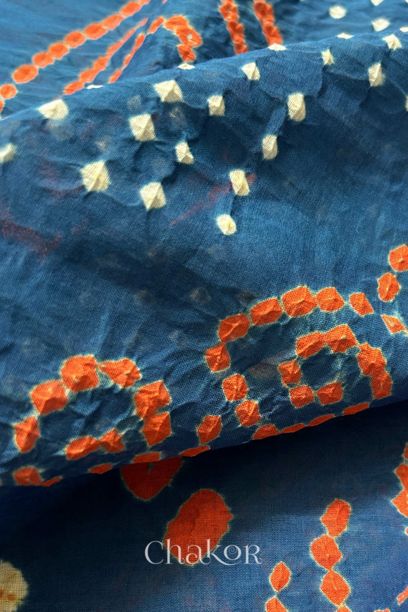 Close up: Handmade Bandhani Cotton Saree with Soft Orange and White Dots in Earthy Indgio Blue by Chakor.