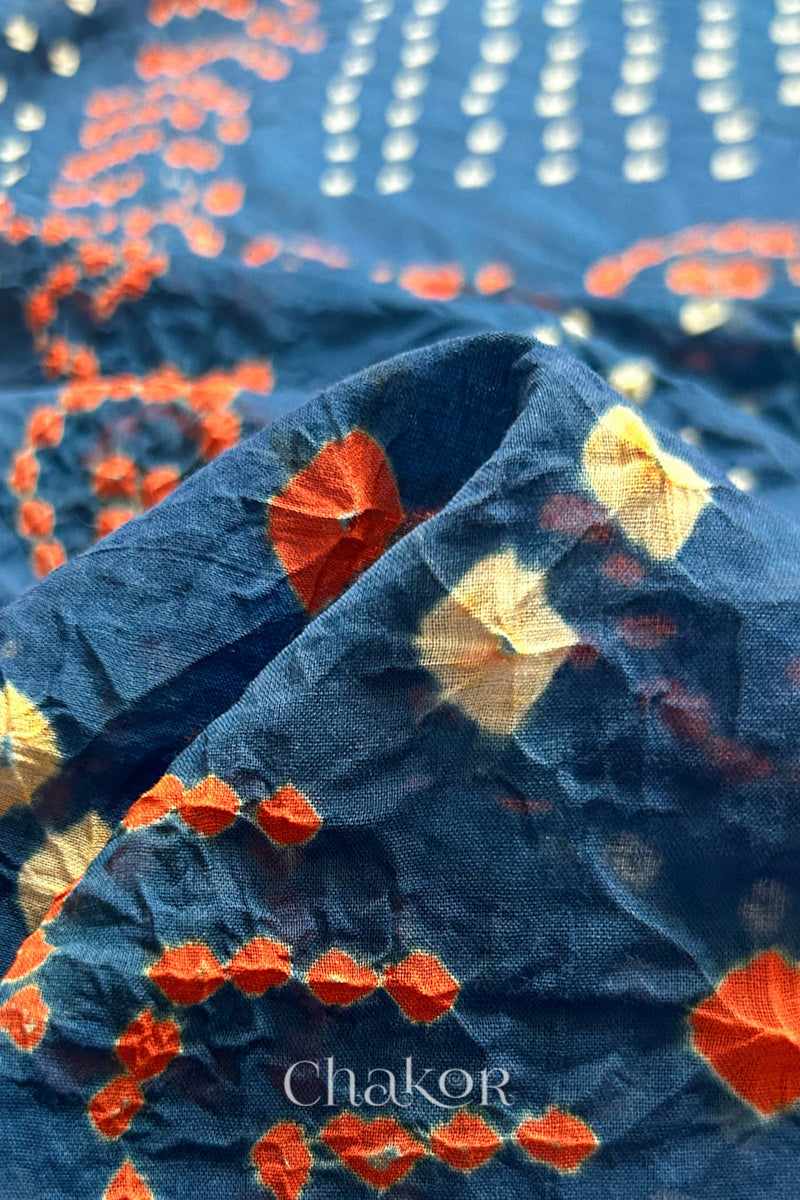 Close up: Handmade Bandhani Cotton Saree with Soft Orange and White Dots in Earthy Indgio Blue by Chakor.