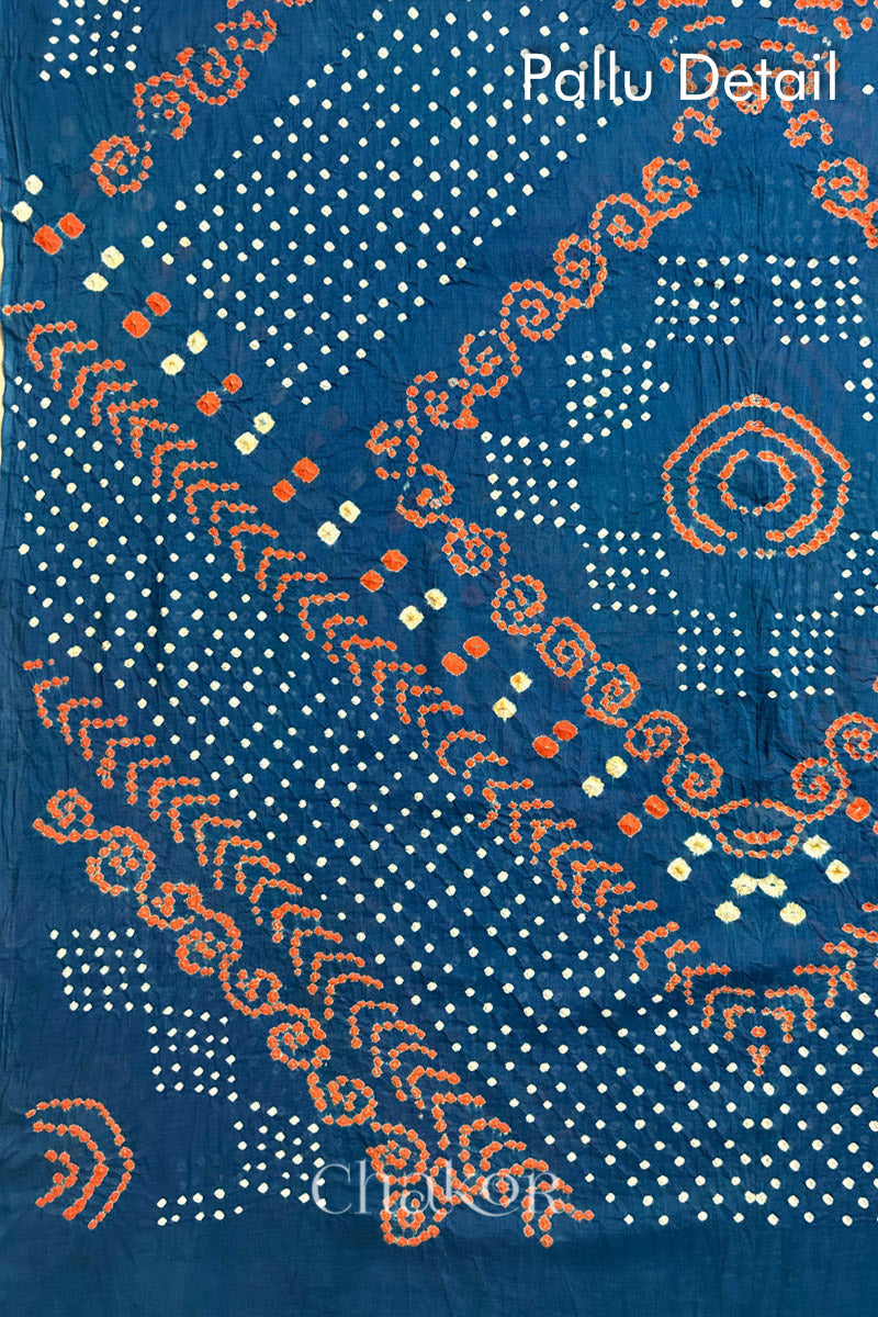 Pallu Detail: Handmade Bandhani Cotton Saree with Soft Orange and White Dots in Earthy Indgio Blue by Chakor.