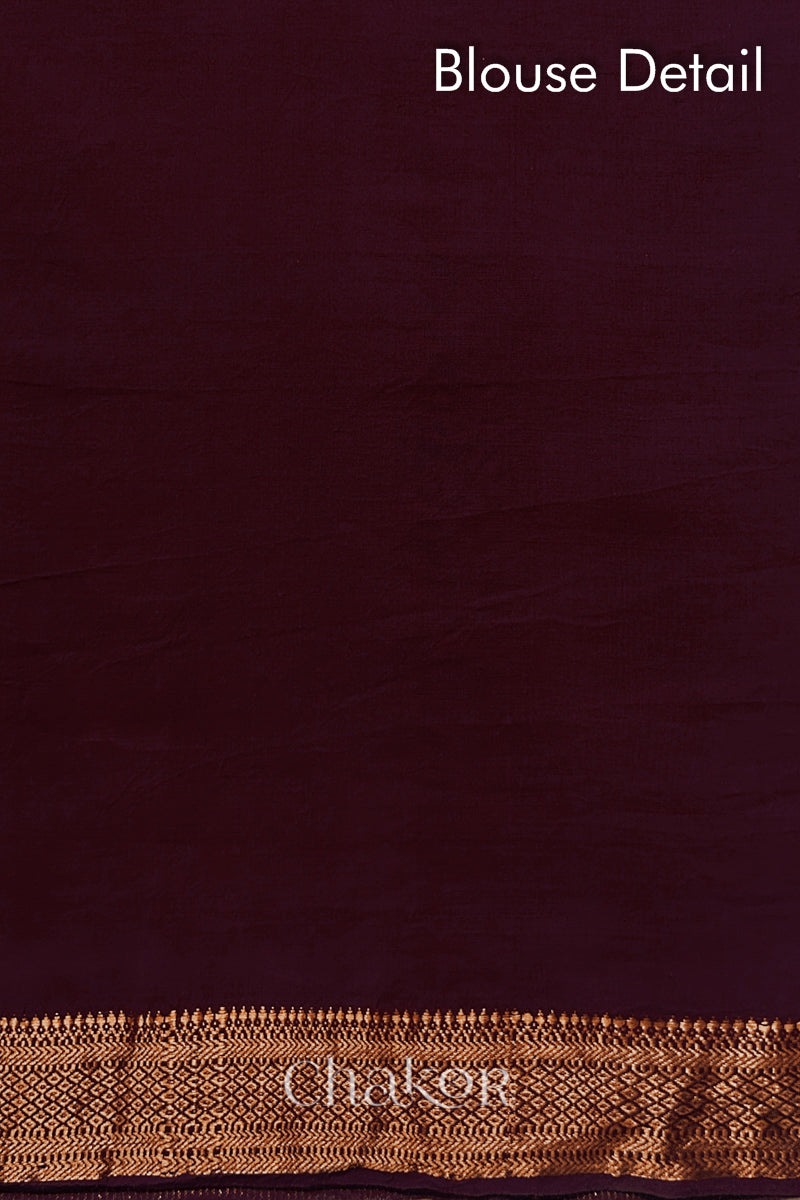 Blouse detail of Maroon bandhani saree with woven golden zari border.
