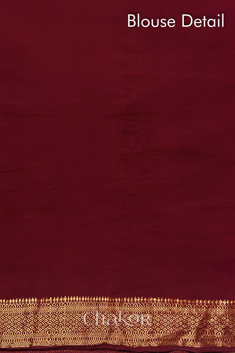 Blouse detail of Red bandhani saree with woven golden zari border.
