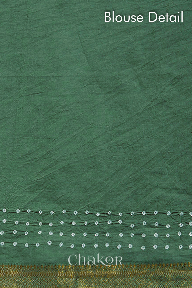 Blouse detail of moss green bandhani saree with white tie-dye dots & woven golden zari border.
