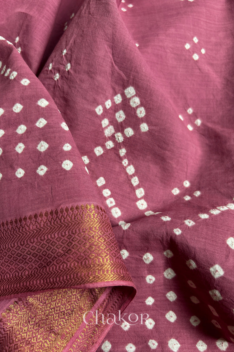 Close-up of old rose saree with rai bandhej showcasing intricate tie-dye craftsmanship.
