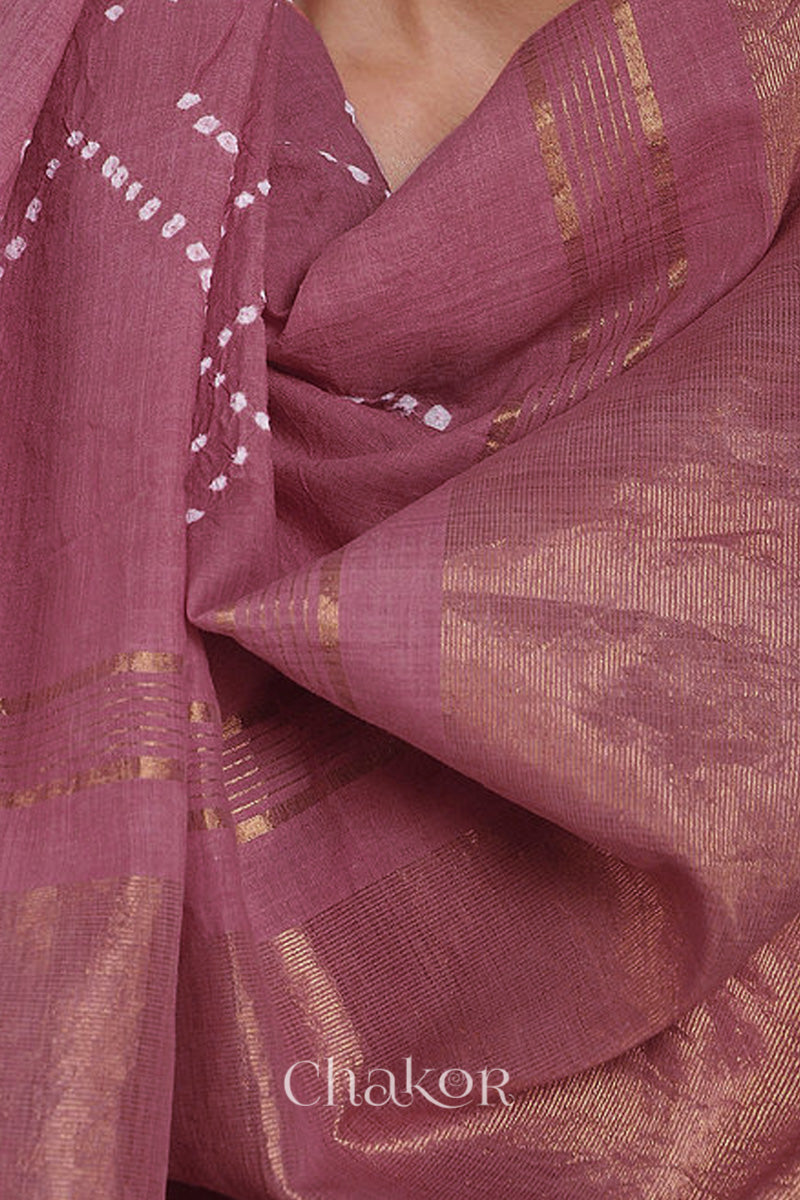 Pallu detail of old rose bandhani saree with woven golden zari border and pallu.
