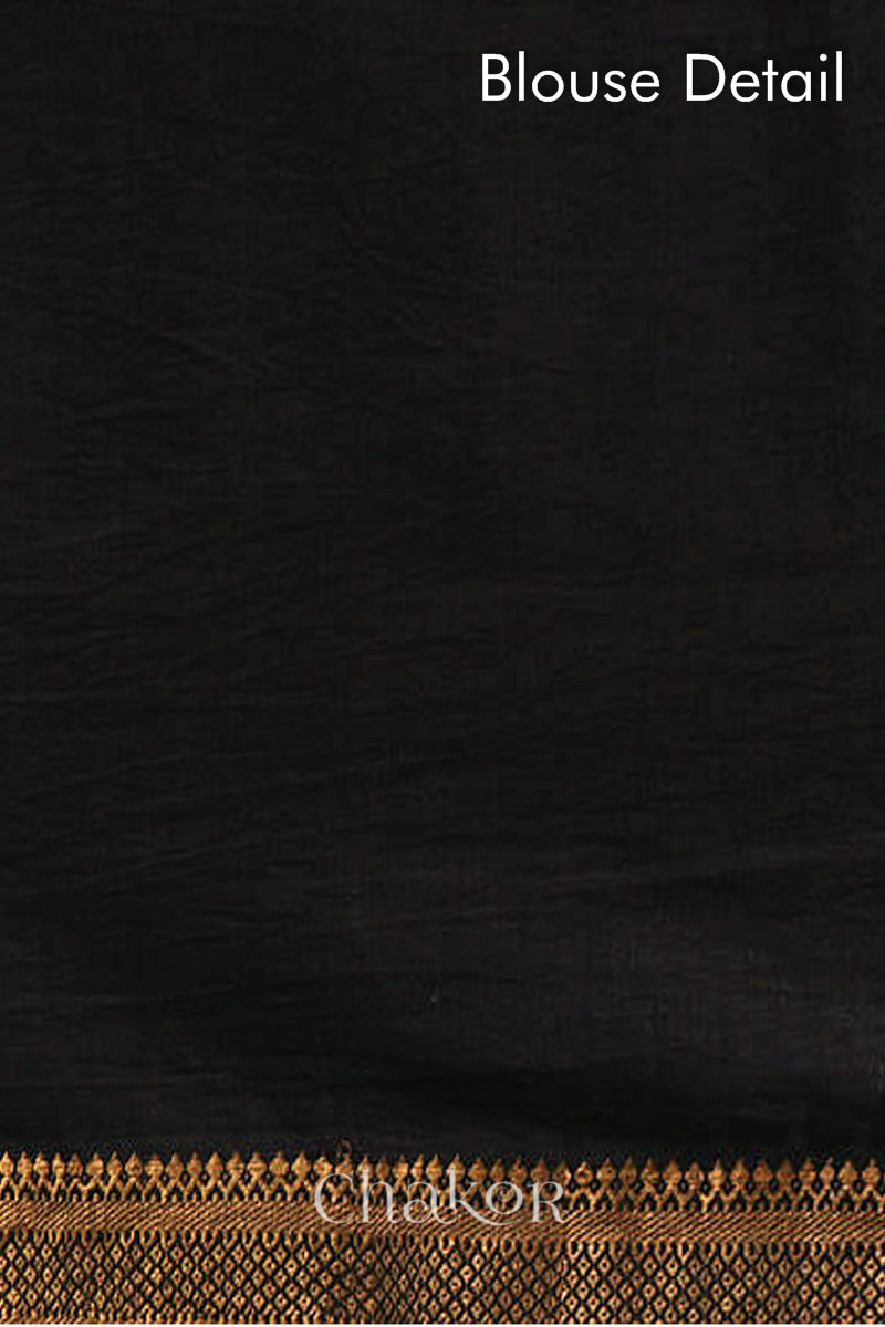 Blouse detail of black bandhani saree with woven golden zari border.
