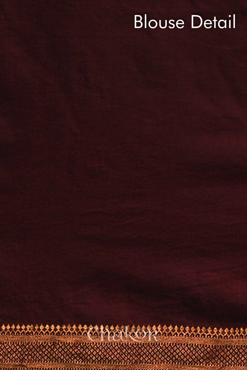 Blouse detail of maroon bandhani saree with woven golden zari border.
