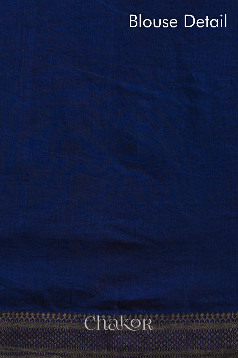 Close-up of navy blue saree with rai bandhej pallu and dull golden border showcasing intricate tie-dye craftsmanship.
