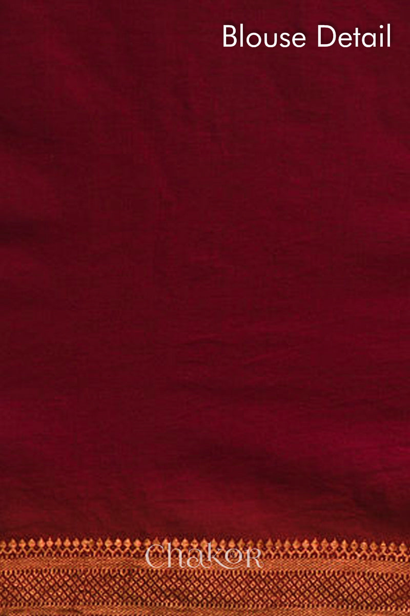 Blouse detail of red bandhani saree with woven golden zari border.
