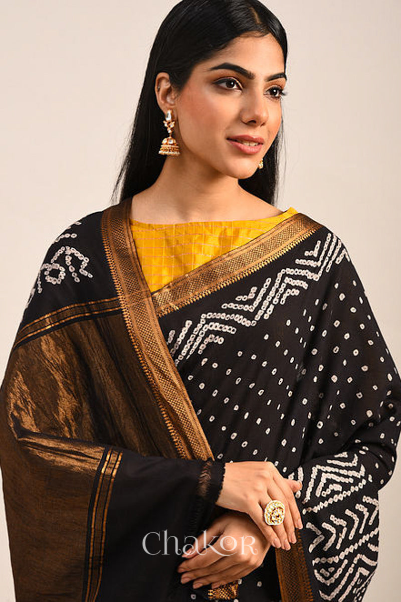 Black Bandhani Mangalgiri Cotton Saree with zari border and pallu by Chakor.Black Bandhani Mangalgiri Cotton Saree with zari border and pallu by Chakor.