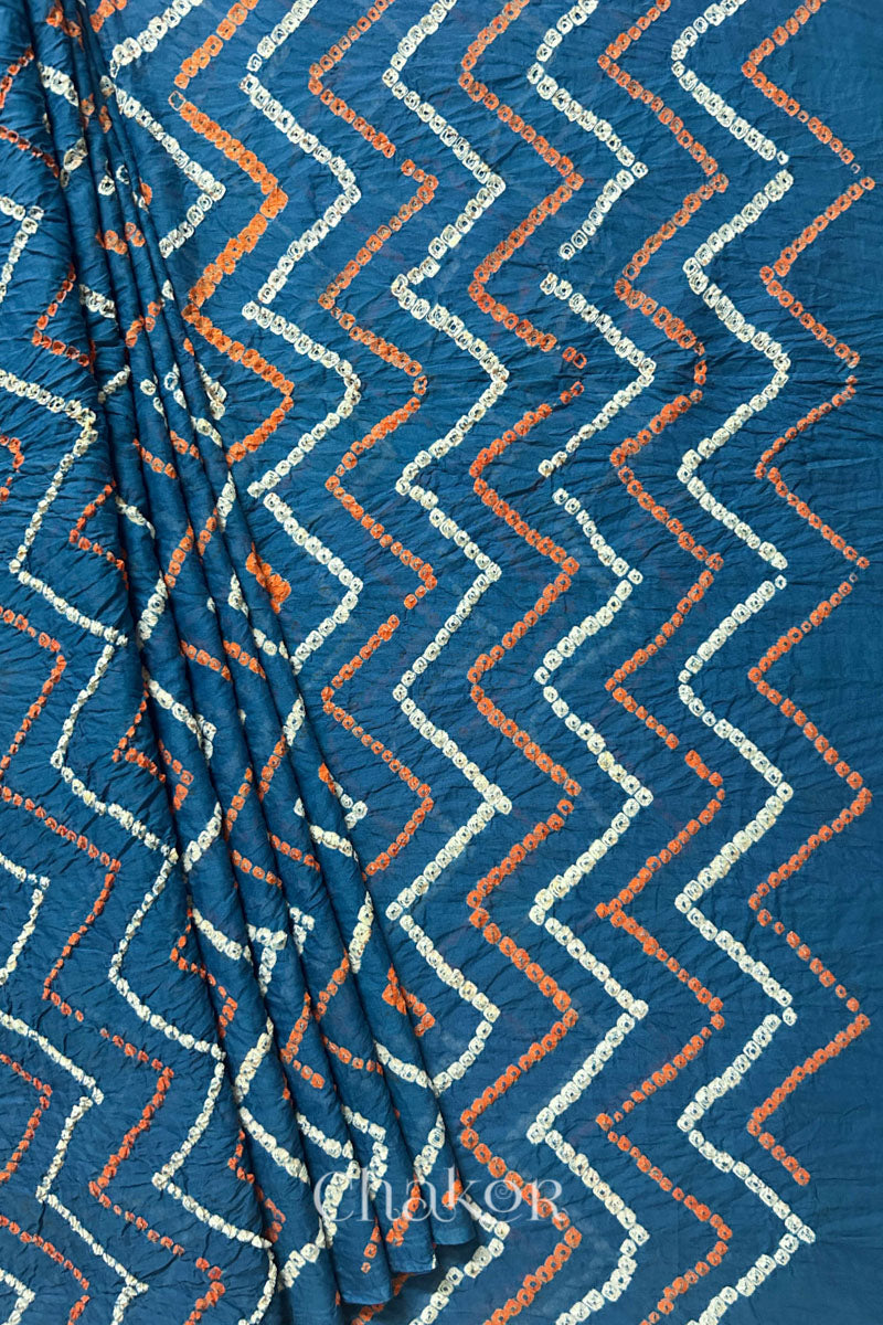Pleats and pallu view of Indigo Blue Bandhani Mul Cotton Saree with zigzag patterns in yellow and white bandhej dots.