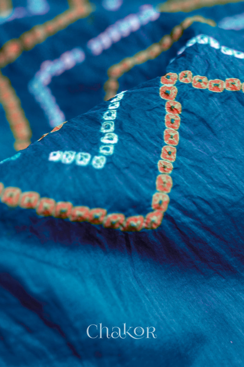Close up of Indigo Blue Bandhani Mul Cotton Saree with zigzag patterns in yellow and white bandhej dots.