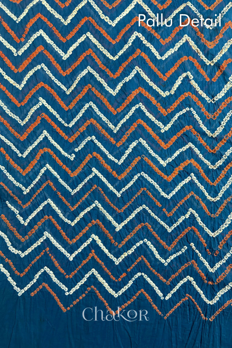 Pallu detail of Indigo Blue Bandhani Mul Cotton Saree with zigzag patterns in yellow and white bandhej dots.