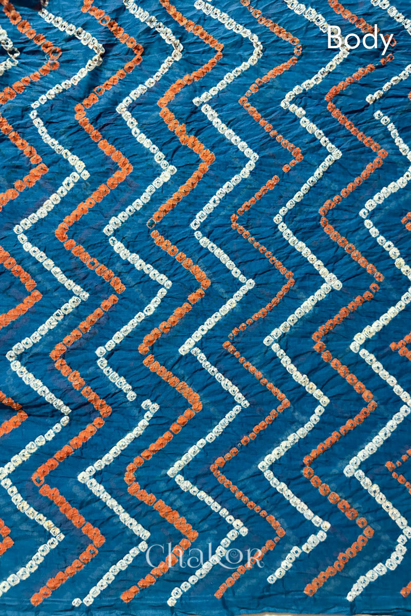 Body detail of Indigo Blue Bandhani Mul Cotton Saree with zigzag patterns in yellow and white bandhej dots.