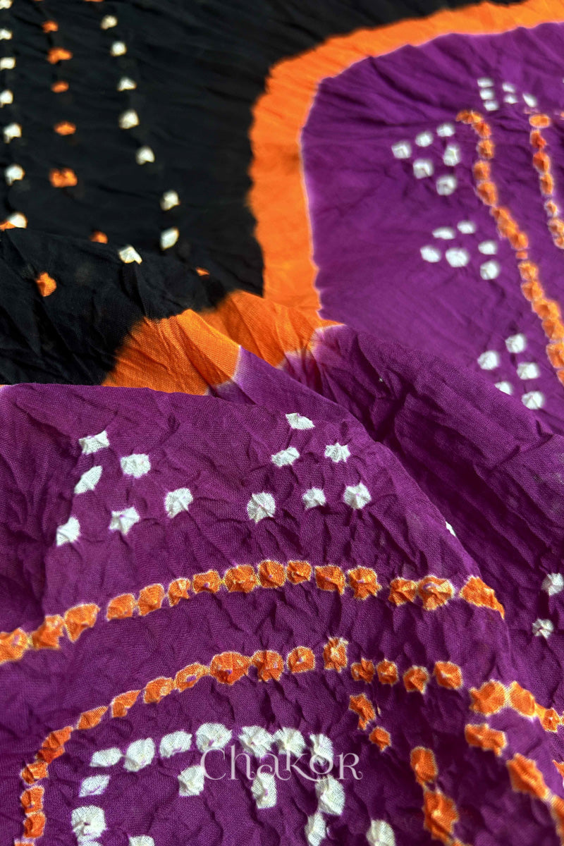 Close up of Black and Magenta Bandhani Mul Cotton Saree featuring multicoloured bandhej patterns.