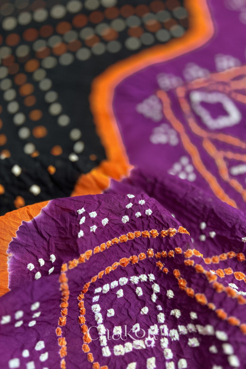 Close up of Black and Magenta Bandhani Mul Cotton Saree featuring multicoloured bandhej patterns.