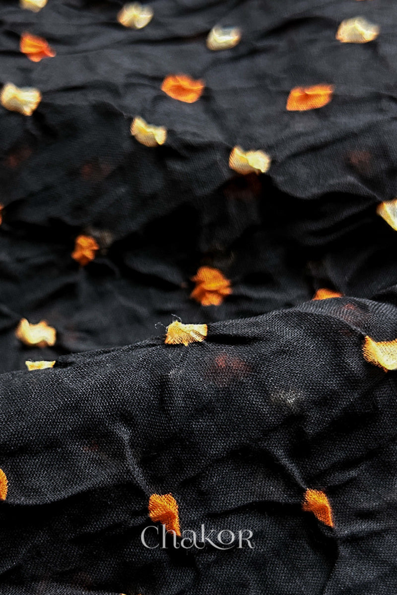 Close up of Black and Magenta Bandhani Mul Cotton Saree featuring multicoloured bandhej patterns.
