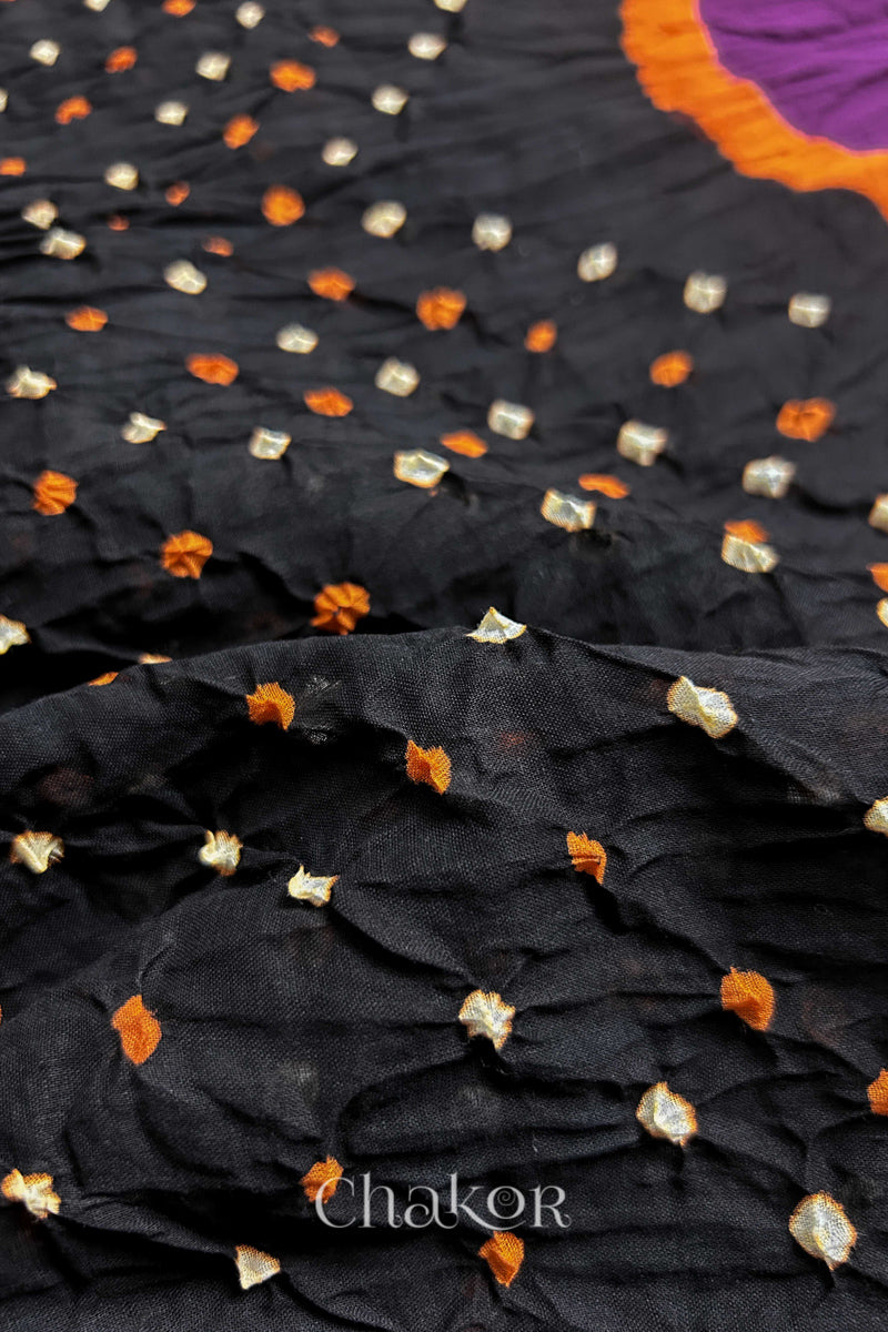 Close up of Black and Magenta Bandhani Mul Cotton Saree featuring multicoloured bandhej patterns.
